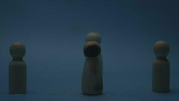 The wooden figure, isolated from the crowd with a fire, being chased away due to confusion and conflict with others. Concepts of dissent, rejection, doubt, anger and revenge. video