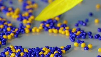 a yellow and blue bead cluster on a table video