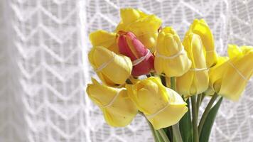 a vase with yellow and red tulips in it video