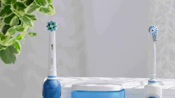 a blue and white electric toothbrush sitting on a table video