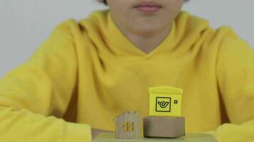 a boy in a yellow sweatshirt sitting on top of a wooden box video