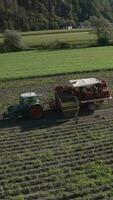 an aerial view of a tractor and trailer loading a truck with potatoes video