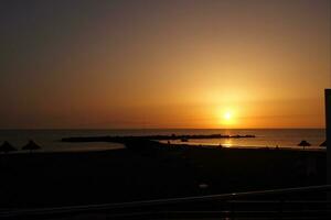 picturesque ocean landscape with the setting sun in a tropical country during summer holidays photo