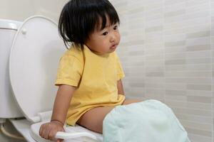 child going to the toilet, constipation in children, dyspepsia, abdominal pain, crying, defecating, straining, urinary incontinence, blood in the stool, bowel problems, ulcerative colitis, diarrhea photo