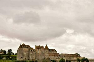 a castle with a cloudy sky photo