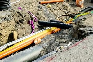 a group of wires and pipes laying on the ground photo