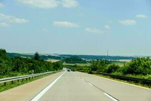 a highway with cars driving down it photo