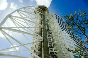 a tall building with a white structure photo