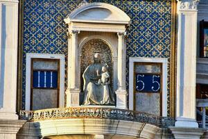 a statue of a woman and child on a building photo