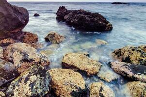 rocks and water in the ocean photo