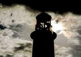 The silhouette of a lighthouse photo