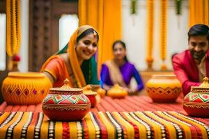 a couple in traditional indian attire sit at a table with colorful pots. AI-Generated photo