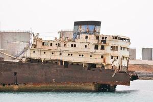 an abandoned ship is in the water photo