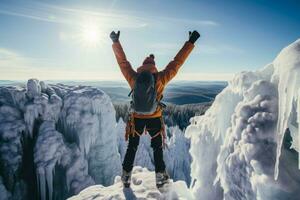 Triumphant climber atop frozen waterfall background with empty space for text photo