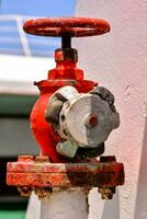 a red and white valve on a boat photo