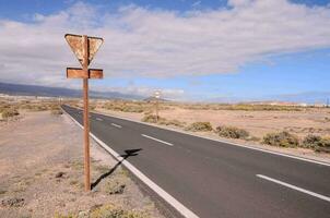 an empty road with a sign on it photo