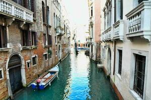 a narrow canal with boats on it photo