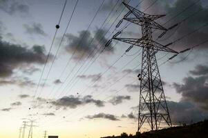 a view of electricity pylons at sunset photo