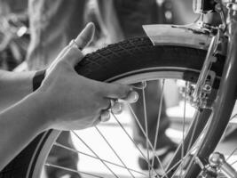 at the bike shop store and repair , mechanic expert repairs check bicycle tire photo