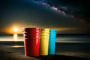three colorful buckets on the beach at night. AI-Generated photo