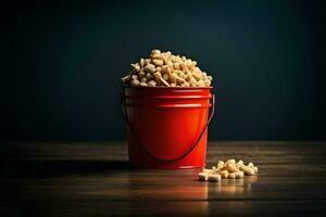 a red bucket filled with peanuts on a wooden table. AI-Generated photo