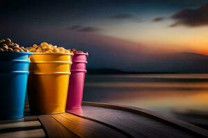 three colorful buckets of popcorn on a wooden table with a sunset in the background. AI-Generated photo