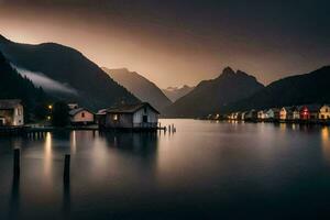 un lago y casas en el montañas a oscuridad. generado por ai foto