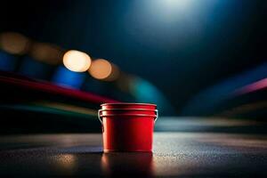 a red bucket sitting on a table in front of a blurry background. AI-Generated photo