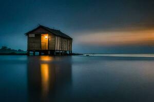 un pequeño casa en el playa a puesta de sol. generado por ai foto