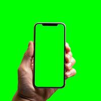 hand shows mobile smartphone with green screen in vertical position isolated on green background. Mock up mobile photo