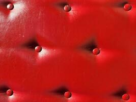 Red leather upholstery. Furniture upholstery with red buttons photo