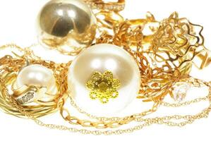 Gold jewelry. Gold and pearls. Pearls with gold on a white background photo