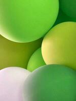 Festive background from balloons. Green balloons. Abstract background photo