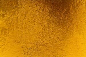 Golden wall plaster glitter texture photo