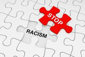 One Piece of Red Jigsaw Puzzle over Plain of White Puzzle with Stop Racism Words. 3d Rendering photo