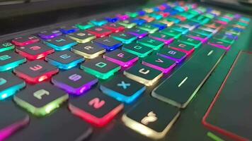 A gaming keyboard that has colorful LED lights, with the main color of the keyboard being black. It has a shape that is very suitable for the hand when typing or playing games. video