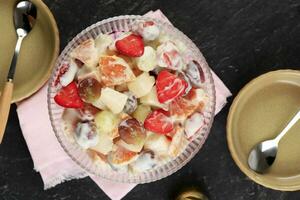 Delicious Creamy Fruit Salad or Salad Buah in a Bowl. photo