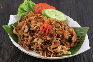 Kwetiaw or Kwetiau, Fried Rice Flat Noodles with Chicken, Meatballs, and Various Vegetables photo