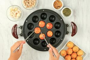Making Homemade Takoyaki, ROund Ball using Chopstick photo