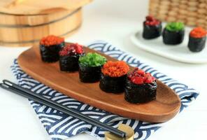 Various Topping Gunkan Sushi on Oval Wooden Plate photo