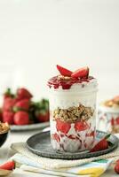 Strawberry Yogurt Parfait with Granola, Mint and fresh Berries photo