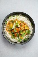 Pumpkin curry with rice and coriander, top view photo