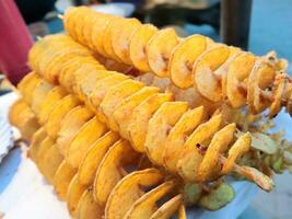 Fried potato chips in the market, closeup of photo. photo