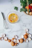 Eggs, vegetables and whisk in a bowlle background photo