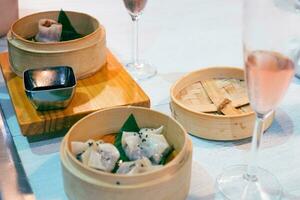 Chinese dim sum in bamboo steamer on table. Chinese traditional food photo