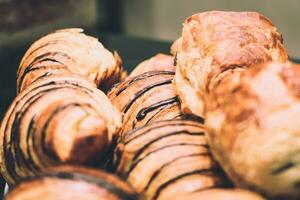 Freshly baked croissants in a bakery shop. Toned. photo