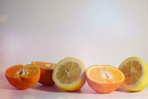 Orange, lemon and grapefruit on a white background with space for text photo