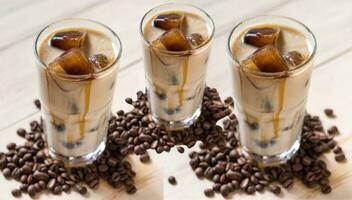 Iced coffee with cream and coffee beans on a wooden background. photo