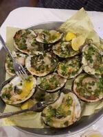 Fresh oysters with green onion, garlic and lemon on the plate photo