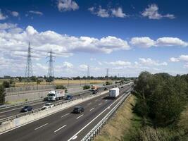 cars trucks person and stocks on motorway photo